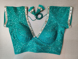 Buy beautiful sea green sequin saree blouse online in USA with mirror work lace. Elevate your Indian ethnic saree looks with beautiful readymade sari blouse, embroidered saree blouses, Banarasi saree blouse, designer saree blouses, sleeveless saree blouses from Pure Elegance Indian fashion store in USA.-front