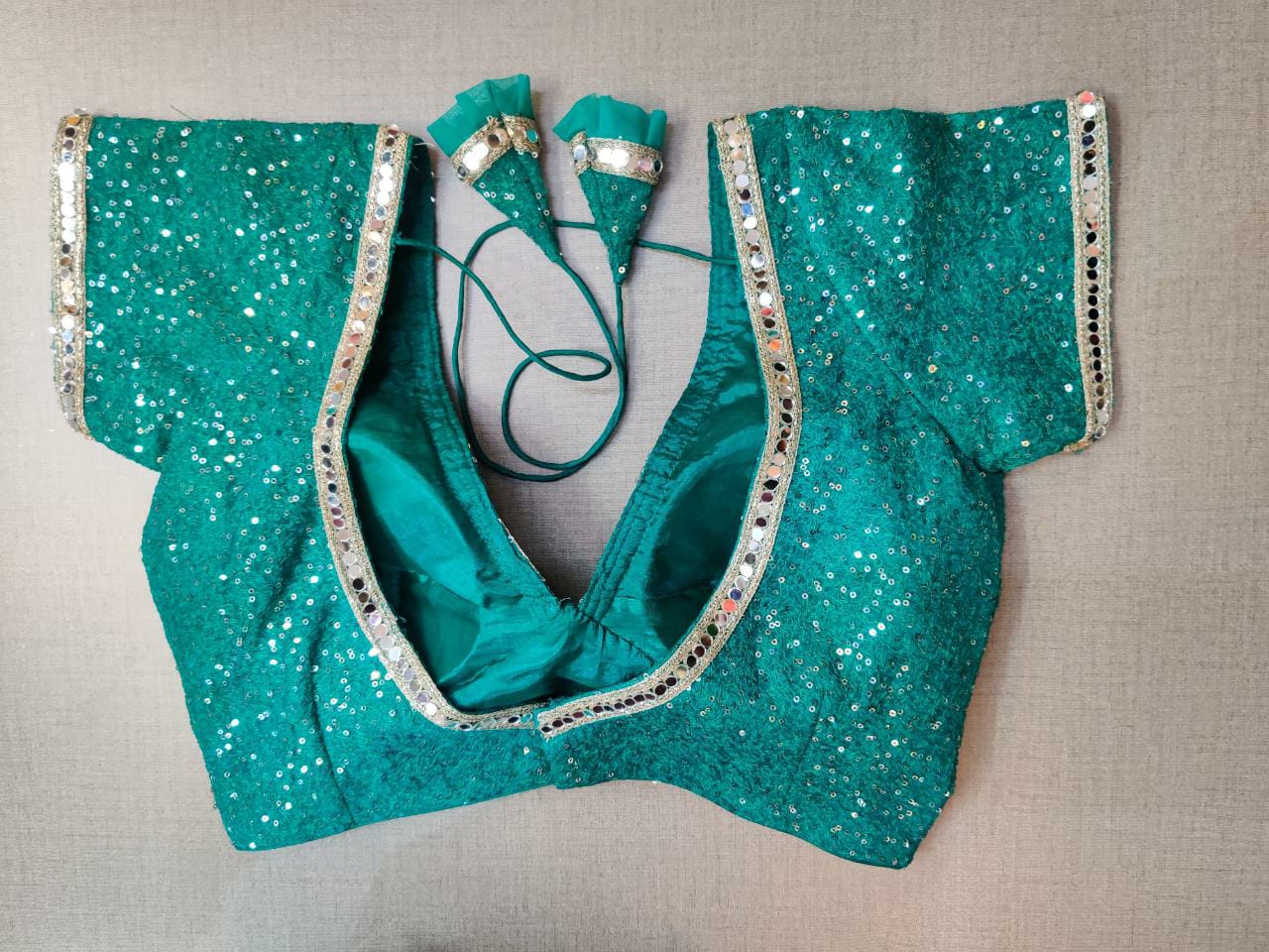 Buy beautiful sea green sequin saree blouse online in USA with mirror work lace. Elevate your Indian ethnic saree looks with beautiful readymade sari blouse, embroidered saree blouses, Banarasi saree blouse, designer saree blouses, sleeveless saree blouses from Pure Elegance Indian fashion store in USA.-back