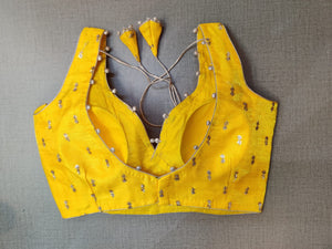 Shop stunning yellow embroidered sleeveless saree blouse online in USA. Elevate your Indian ethnic saree looks with beautiful readymade sari blouse, embroidered saree blouses, Banarasi saree blouse, designer saree blouses, sleeveless saree blouses from Pure Elegance Indian fashion store in USA.-back