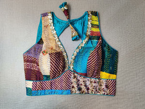 Shop beautiful blue and brown patch work designer sari blouse online in USA with Kantha stitch. Elevate your Indian ethnic saree looks with beautiful readymade saree blouse, embroidered saree blouses, Banarasi saree blouse, designer sari blouses, sleeveless saree blouses from Pure Elegance Indian fashion store in USA.-front