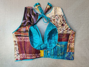 Shop beautiful blue and brown patch work designer sari blouse online in USA with Kantha stitch. Elevate your Indian ethnic saree looks with beautiful readymade saree blouse, embroidered saree blouses, Banarasi saree blouse, designer sari blouses, sleeveless saree blouses from Pure Elegance Indian fashion store in USA.-back