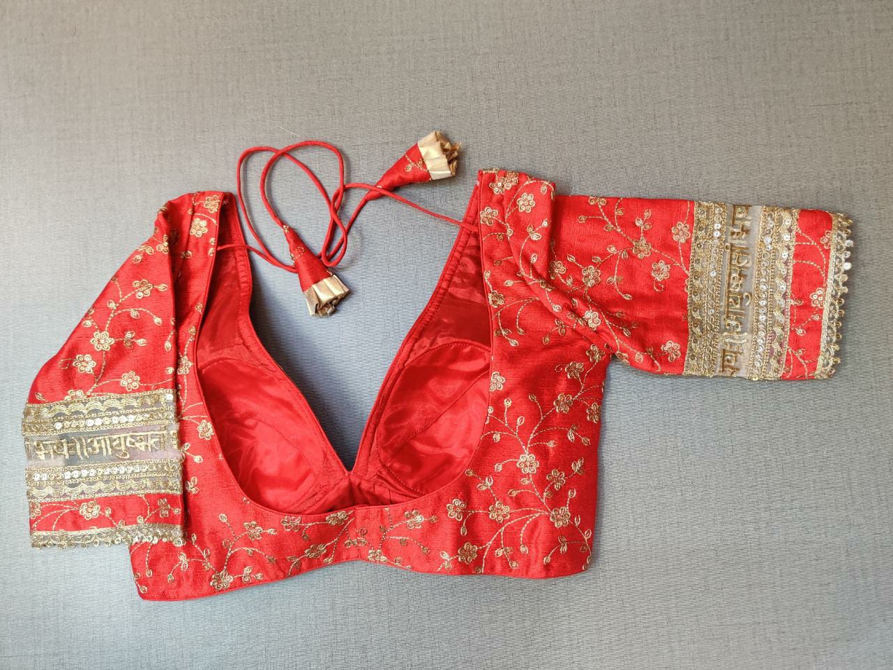 Buy stunning red saree blouse online in USA with golden floral embroidery. Elevate your Indian ethnic saree looks with beautiful readymade saree blouse, embroidered saree blouses, Banarasi saree blouse, designer sari blouses, sleeveless saree blouses from Pure Elegance Indian fashion store in USA.-back