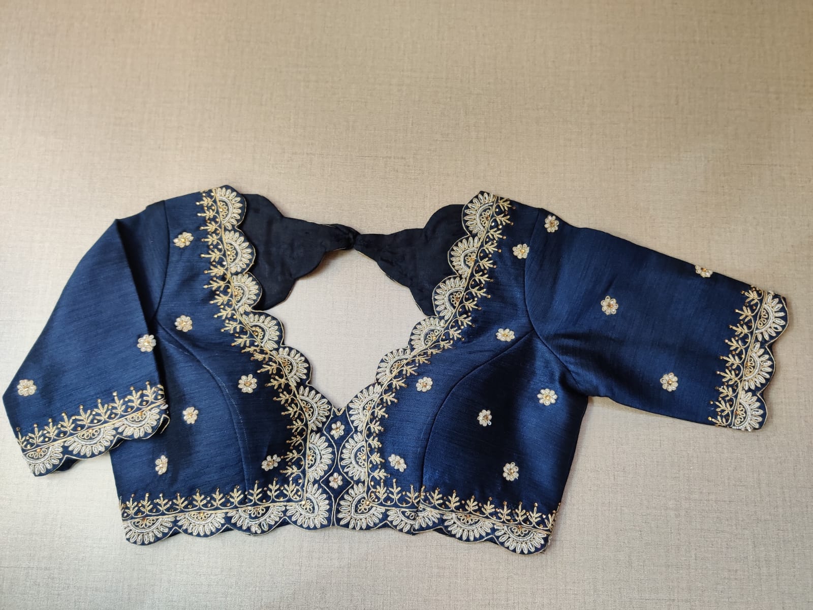 Buy beautiful dark blue embroidered saree blouse online in USA. Elevate your Indian ethnic saree looks with beautiful readymade saree blouse, embroidered saree blouses, Banarasi saree blouse, designer sari blouses, sleeveless saree blouses from Pure Elegance Indian fashion store in USA.-front