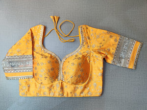 Shop stunning yellow embroidered saree blouse online in USA with mantra sleeves. Elevate your Indian ethnic saree looks with beautiful readymade saree blouse, embroidered saree blouses, Banarasi saree blouse, designer sari blouses, sleeveless saree blouses from Pure Elegance Indian fashion store in USA.-front