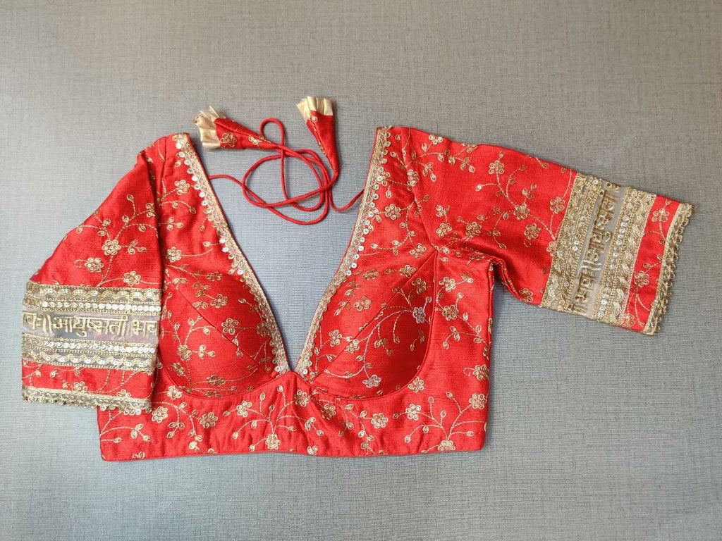 Buy Red and gold-coloured embroidered saree blouse has a deep neck, floral and back open with hook online in USA. Pair this fancy designer sari blouse crafted with beautiful golden lace border, dori ties with ethnic sari, designer saree blouses online, sari blouses from Pure Elegance Indian fashion store in USA.- Front.