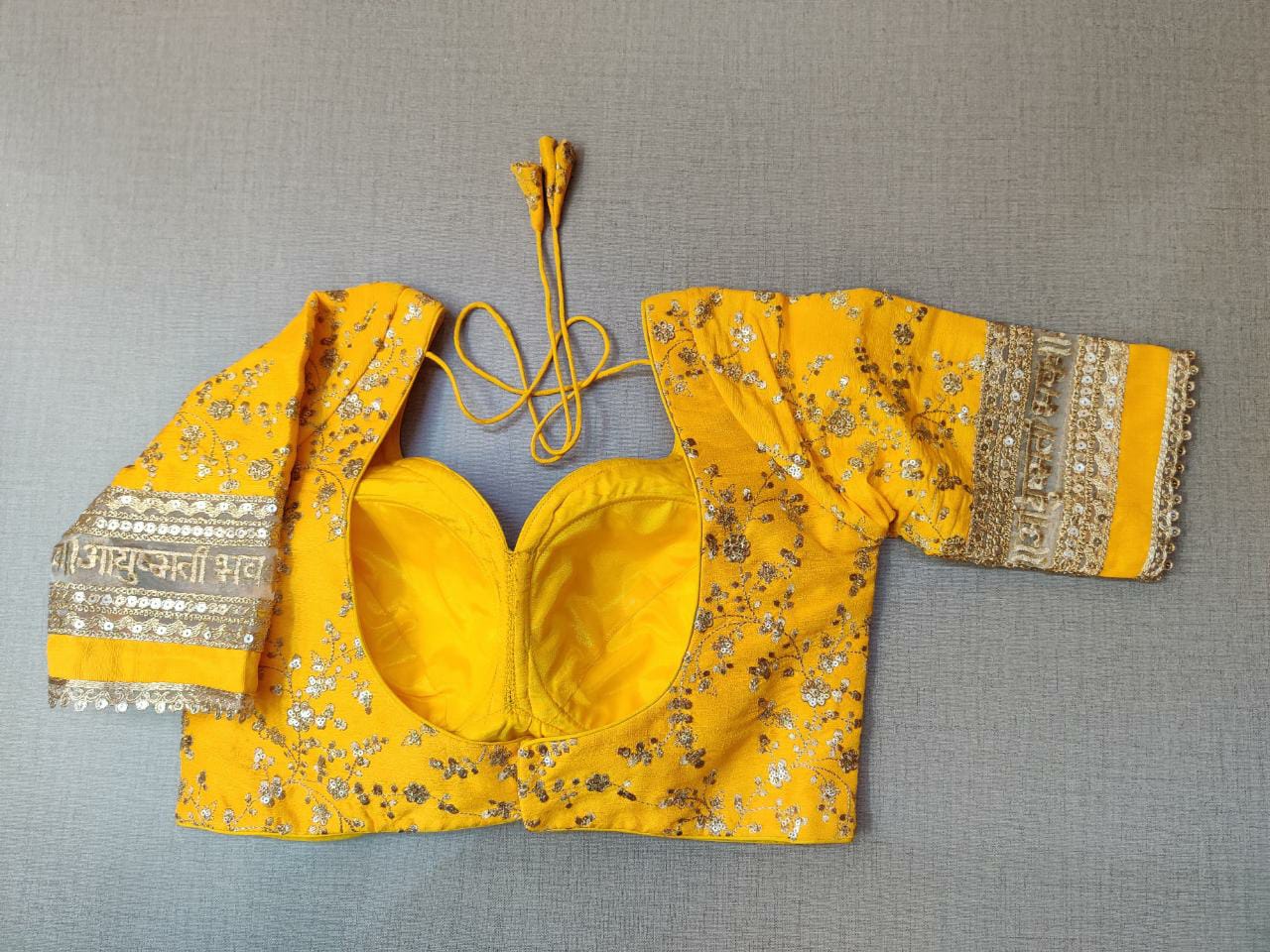 Buy yellow embroidered designer saree blouse with golden lace border,floral pattern and back open with hook online in USA. Pair this fancy designer sari blouse with mantra lace border, dori ties and long sleeve with ethnic sari, designer saree blouses online, sari blouse from Pure Elegance Indian fashion store in USA.- Back.