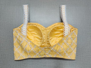 Shop this classy light yellow silk designer saree blouse with thread work online in USA. This blouse is the perfect fit for your festive outift needs. Enjoy a comfortable day ahead with the carefully crafted silk fabric with sweetheart neckline, sleeveless, sari blouses online, sari blouse from Pure Elegance Indian fashion store in USA.-Back view.