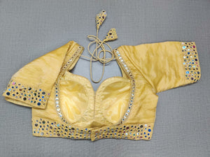 Buy this exquisite yellow silk designer saree blouse with mirror work online in USA. This blouse is the perfect fit for your festive outfit needs. Enjoy a comfortable day ahead with the carefully crafted silk fabric with sweetheart neckline, long sleeve, sari blouses online, sari blouse from Pure Elegance Indian fashion store in USA.-Back view.