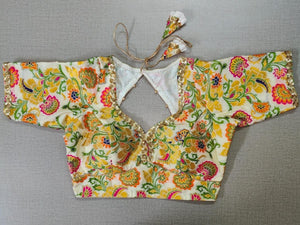 Buy Multi-colored Floral Embroided Cream Colour Based Blouse, beautifully Designed Back with Golden Work and Tassels. This charming Blouse surely fetch you Compliments for your rich sense of Style. Pair this embroidered saree blouse with any Silk Designer Saree or Embroided sarees from Pure Elegance Indian clothing store in USA.-Front View