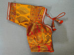 Buy Gorgeous orange and Bright Yellow gold embroidered Silk blouses for designer sarees. You can pair it up with any Indian Silk saree for making a festive look. . Elevate your Indian saree style with a readymade sari blouse, embroidered saree blouses, and Banarasi sari blouse, and designer sari blouse from Pure Elegance Indian clothing store in USA.-Folded View