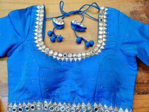 Shop gorgeous blue mirror embroidery designer saree blouse online in USA. Elevate your ethnic saree style with a tasteful collection of designer saree blouses, embroidered sari blouses, Banarasi blouses, silk saree blouses from Pure Elegance Indian clothing store in USA.-front