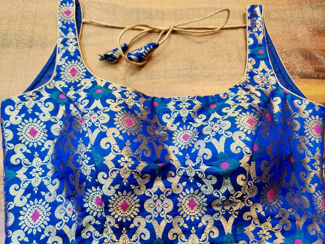Shop stunning ink blue sleeveless Banarsi silk sari blouse online in USA. Elevate your ethnic saree style with a tasteful collection of designer saree blouses, embroidered sari blouses, Banarasi blouses, silk saree blouses from Pure Elegance Indian clothing store in USA.-front