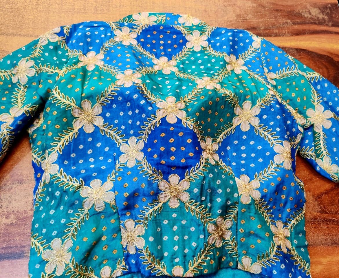 Shop stunning blue bandhej silk embroidered designer saree blouse online in USA. Elevate your ethnic saree style with a tasteful collection of designer saree blouses, embroidered sari blouses, Banarasi blouses, silk saree blouses from Pure Elegance Indian clothing store in USA.-back