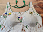 Buy stunning cream embroidered sleeveless saree blouse online in USA. Elevate your ethnic saree style with a tasteful collection of designer sari blouses, embroidered saree blouses, Banarasi blouse, silk saree blouse from Pure Elegance Indian clothing store in USA.-front