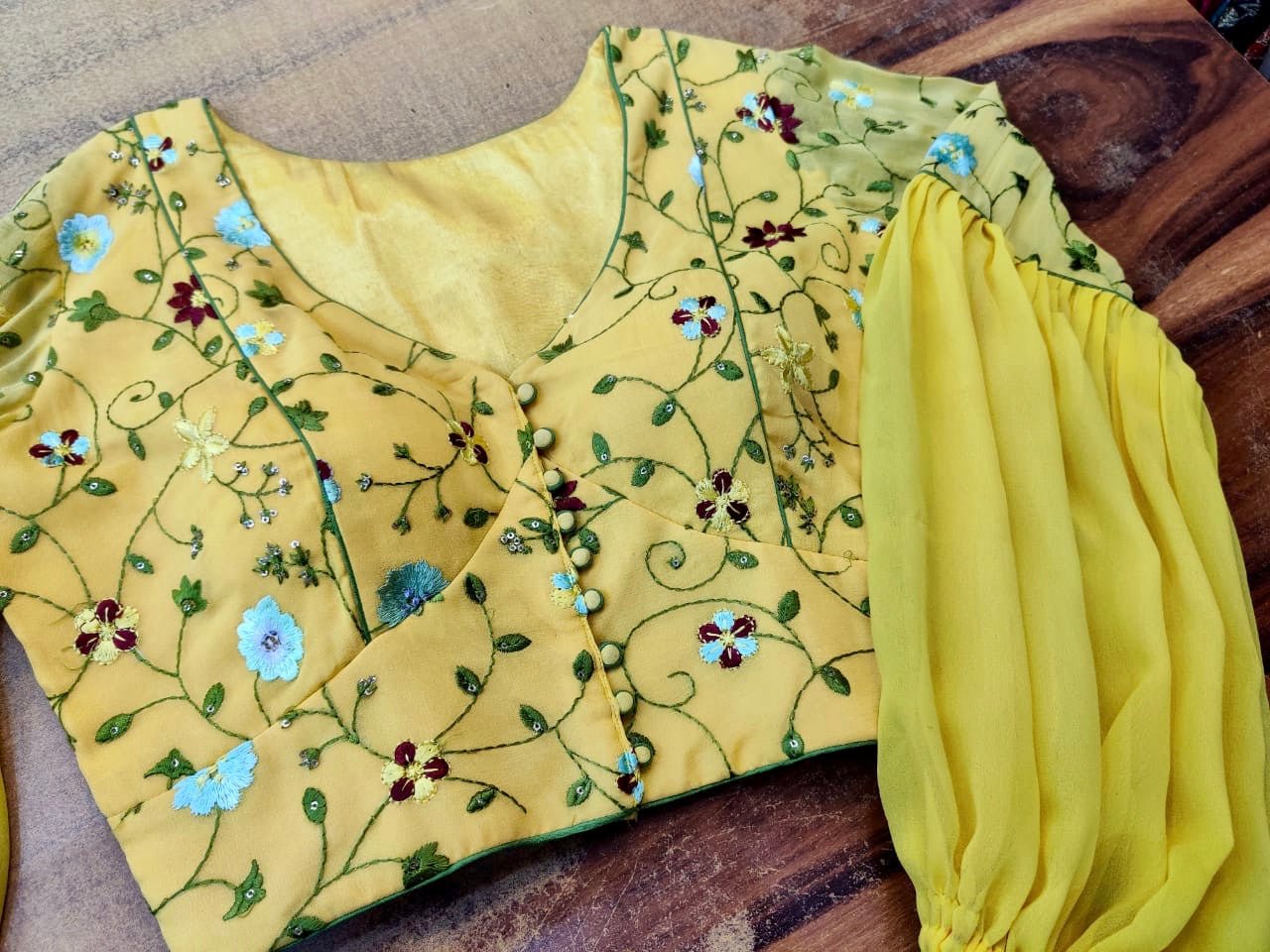 Buy beautiful yellow embroidered designer saree blouse online in USA with sheer sleeves. Elevate your ethnic saree style with a tasteful collection of designer sari blouses, embroidered saree blouses, Banarasi blouse, silk sari blouse from Pure Elegance Indian clothing store in USA.-front