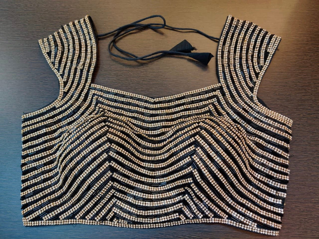 Shop beautiful black stone work designer saree blouse online in USA. Elevate your ethnic sari style with a stunning collection of designer sari blouses, embroidered saree blouses, Banarasi sari blouse, fancy sari blouse from Pure Elegance Indian clothing store in USA.-front