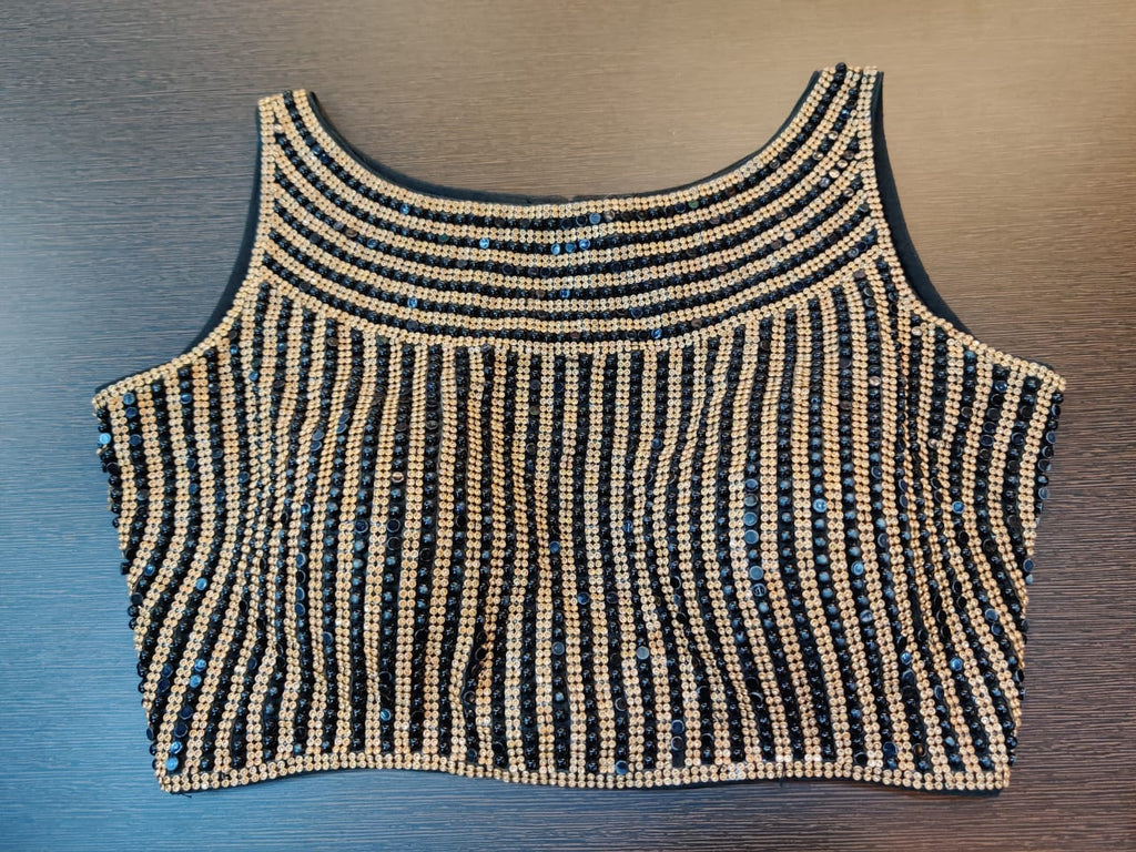 Shop beautiful gold and black stone work fancy saree blouse online in USA. Elevate your ethnic sari style with a stunning collection of designer sari blouses, embroidered sari blouses, Banarasi sari blouse, fancy sari blouse from Pure Elegance Indian clothing store in USA.-front