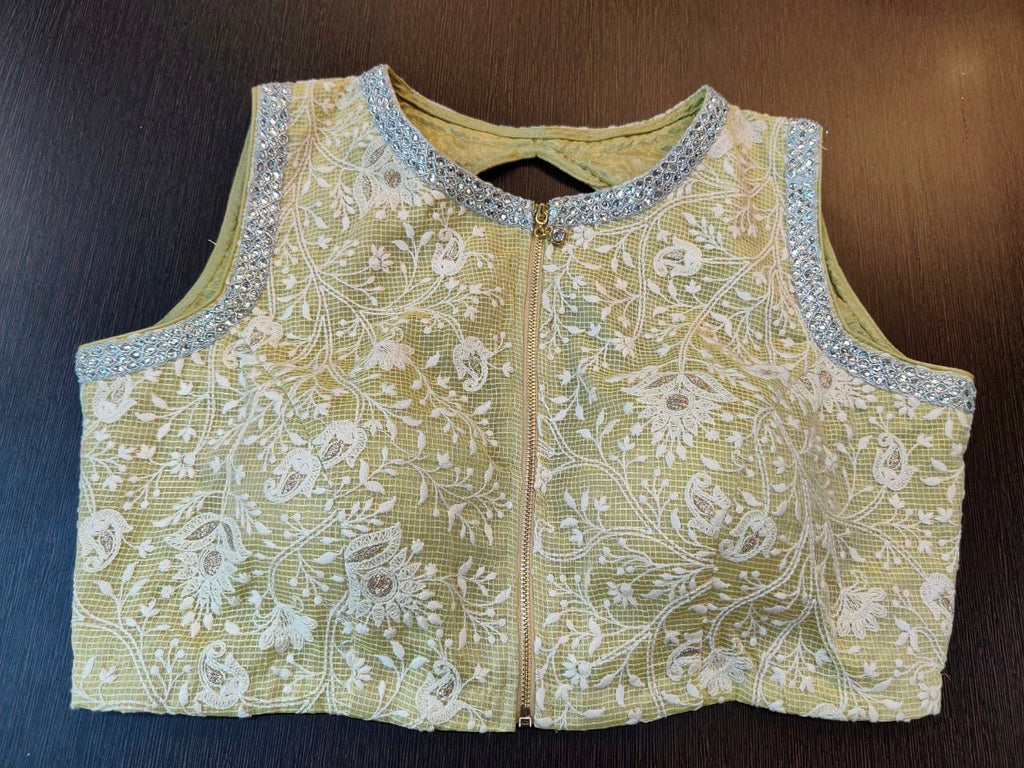Buy stunning cream sleeveless saree blouse online in USA with floral embroidery. Elevate your Indian saree style with exquisite designer sari blouses, embroidered saree blouses, Banarasi saree blouse, fancy saree blouse from Pure Elegance Indian clothing store in USA.-front