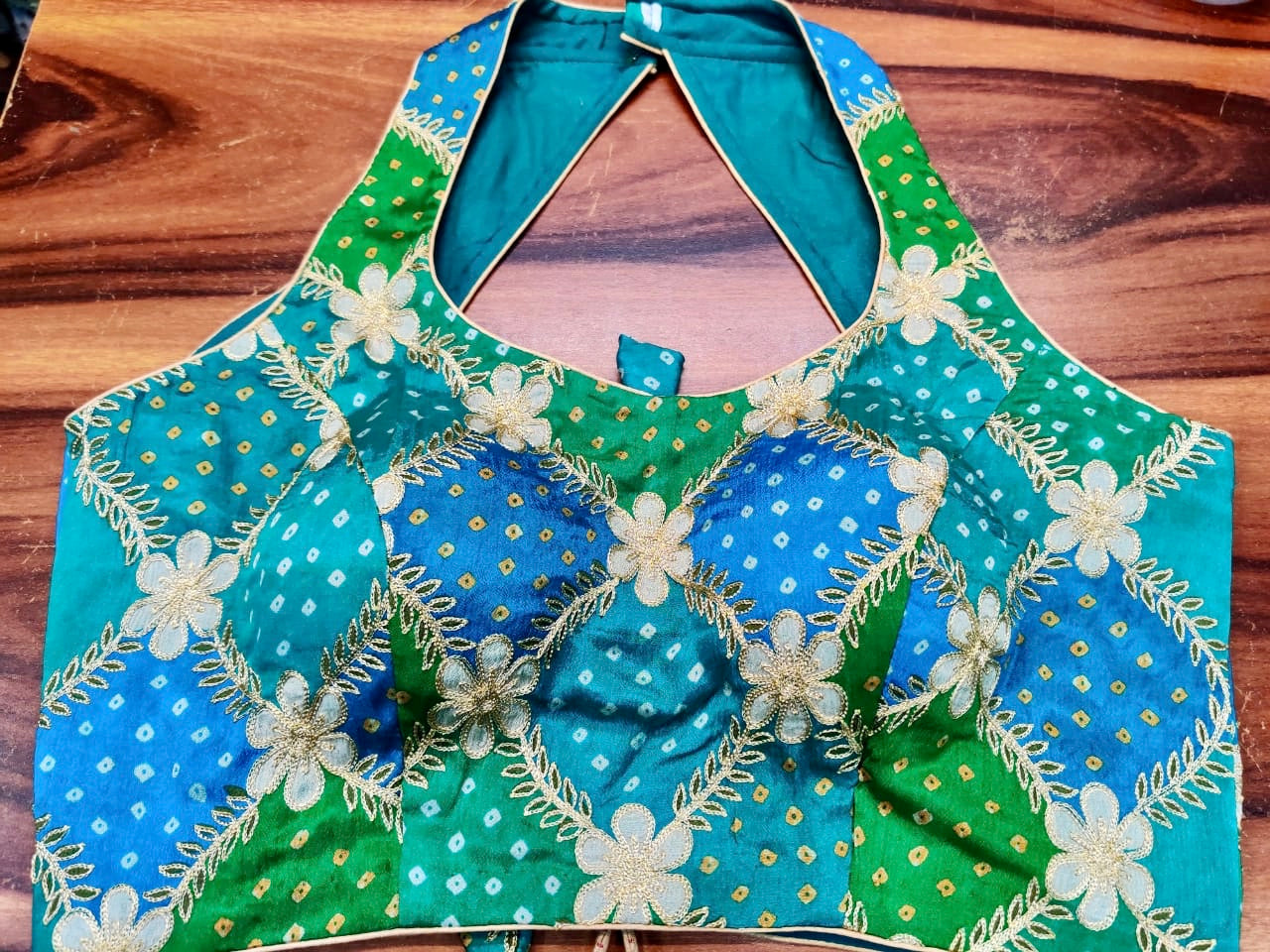Buy beautiful blue and green embroidered Bandhej halter neck sari blouse online in USA. Elevate your Indian saree style with exquisite readymade sari blouses, embroidered saree blouses, Benarasi saree blouse, fancy saree blouse from Pure Elegance Indian clothing store in USA.-front