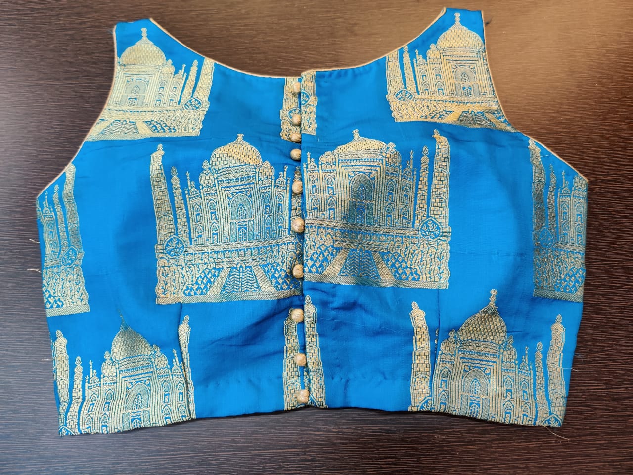 Shop beautiful blue Banarasi sleeveless saree blouse online in USA with Taj Mahal Buta. Elevate your Indian saree style with exquisite readymade saree blouses, embroidered saree blouses, Benarasi saree blouse, fancy saree blouse from Pure Elegance Indian clothing store in USA.-back