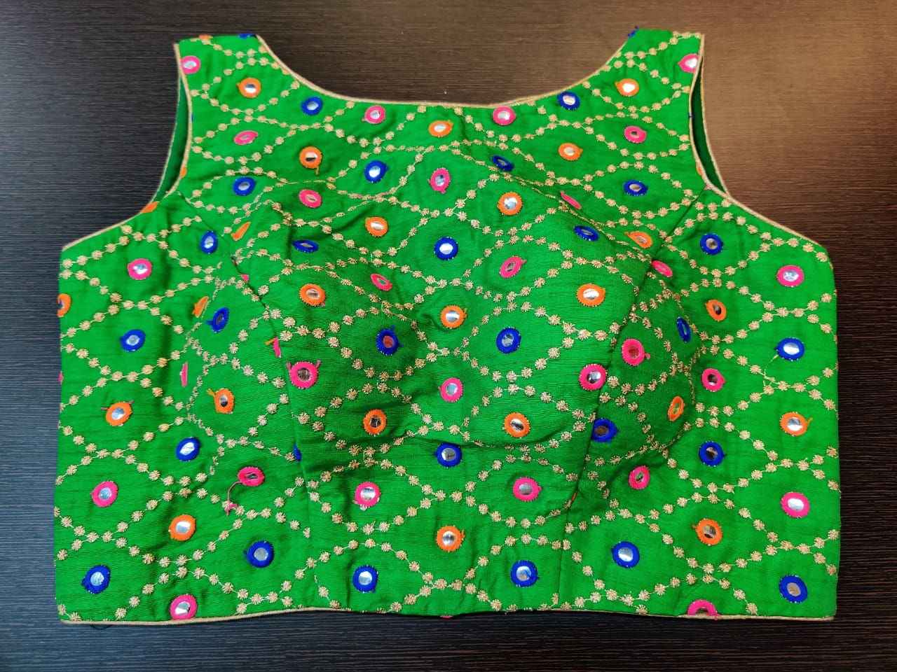 Buy beautiful green mirror work sleeveless saree blouse online in USA. Elevate your Indian saree style with exquisite readymade saree blouses, embroidered saree blouses, Benarasi sari blouse, fancy saree blouse from Pure Elegance Indian clothing store in USA.-front