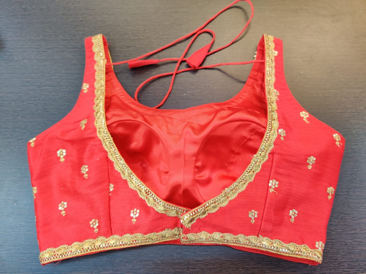 Buy stunning red embroidered sleeveless sari blouse online in USA. Elevate your Indian saree style with exquisite readymade saree blouses, embroidered saree blouses, Benarasi saree blouse, fancy saree blouse from Pure Elegance Indian clothing store in USA.-back