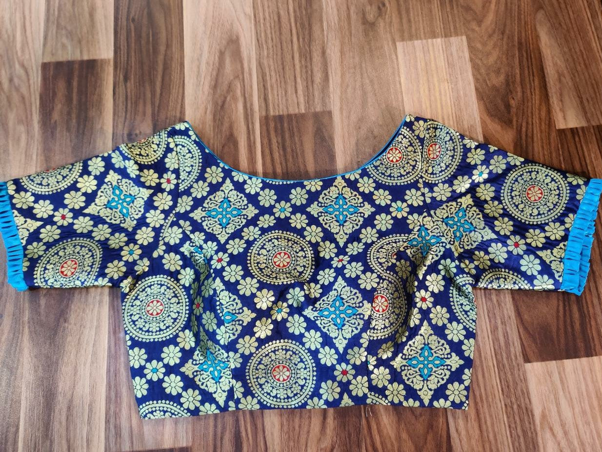 Buy stunning dark blue Banarasi saree blouse online in USA with blue frill sleeves. Elevate your Indian saree style with exquisite readymade saree blouses, embroidered saree blouses, Benarasi saree blouse, fancy saree blouse from Pure Elegance Indian clothing store in USA.-front