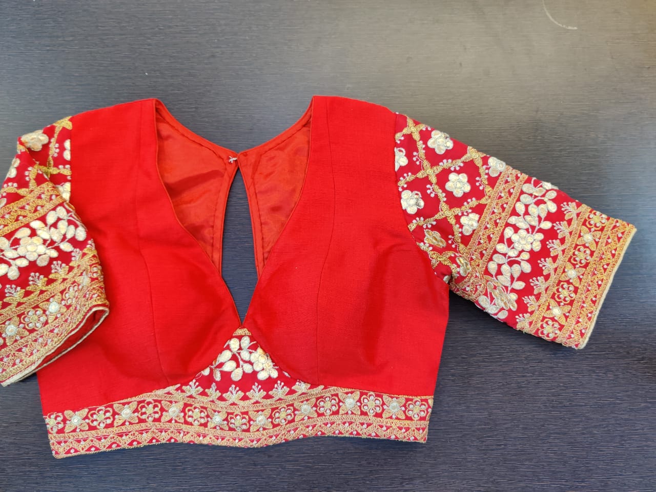 Buy stunning red gota patti work designer saree blouse online in USA. Elevate your Indian saree style with exquisite readymade saree blouses, embroidered saree blouses, Benarasi saree blouse, fancy saree blouse from Pure Elegance Indian clothing store in USA.-front