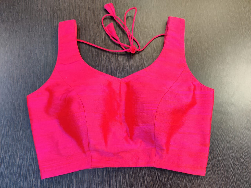 Shop stunning solid pink sleeveless sari blouse online in USA. Elevate your Indian saree style with exquisite readymade saree blouses, embroidered saree blouses, Banarasi saree blouse, fancy saree blouse from Pure Elegance Indian clothing store in USA.-front