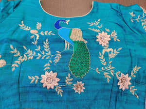 Shop stunning blue designer saree blouse online in USA with embroidered peacock motif on the back. Elevate your Indian saree style with exquisite readymade saree blouses, embroidered saree blouses, Banarasi sari blouse, fancy saree blouse from Pure Elegance Indian clothing store in USA.-back