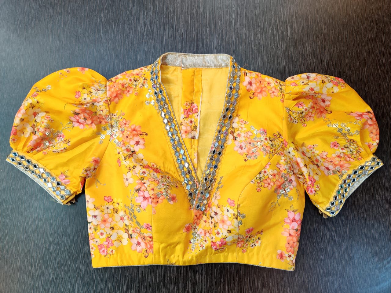 Shop beautiful yellow floral mirror work designer sari blouse online in USA with puff sleeves. Elevate your Indian saree style with exquisite ready made sari blouses, embroidered sari blouses, Benarasi saree blouse, fancy saree blouse from Pure Elegance Indian clothing store in USA.-front