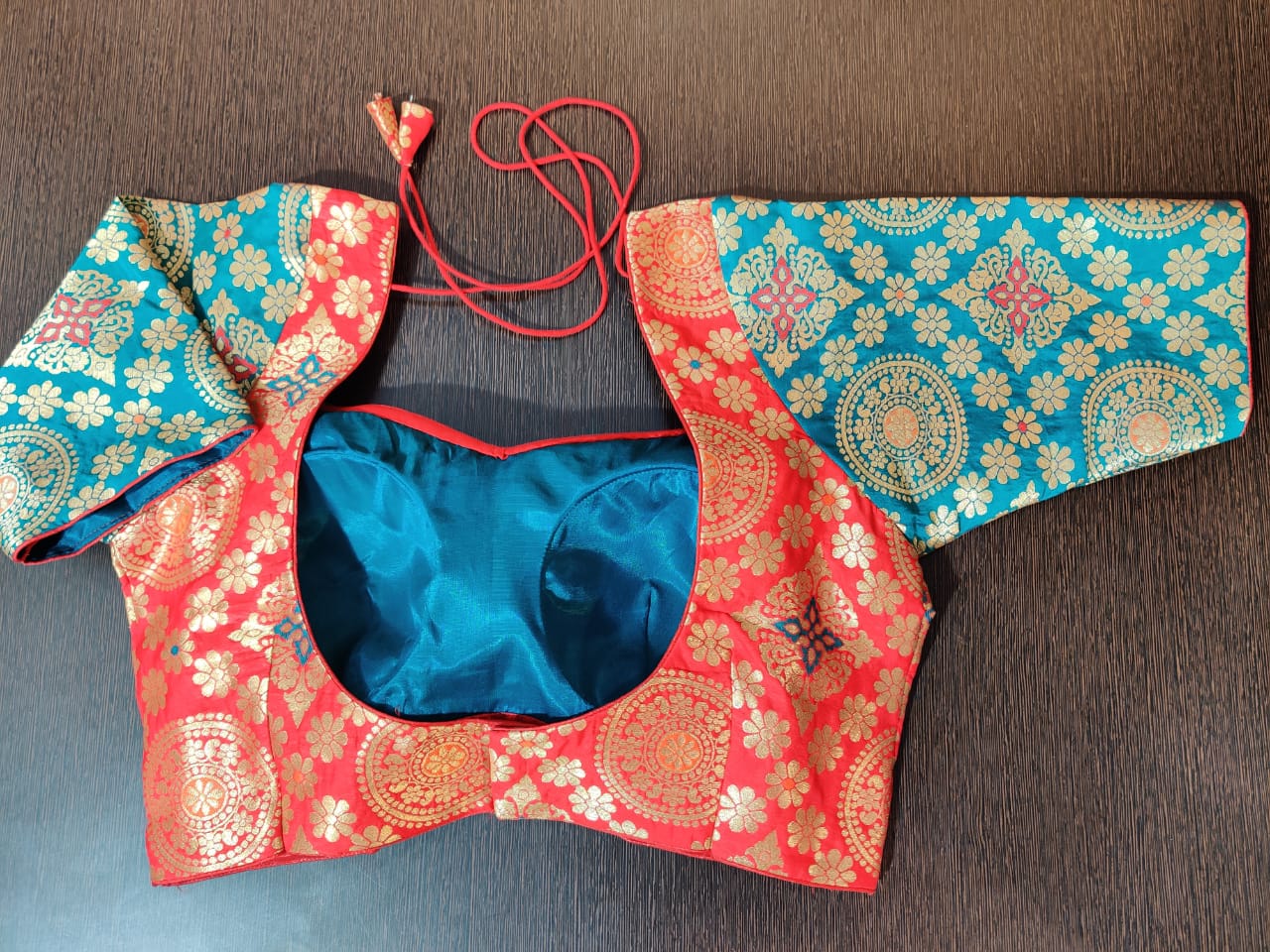 Shop beautiful blue and red Banarasi saree blouse online in USA. Elevate your Indian saree style with exquisite ready made sari blouses, embroidered sari blouses, Benarasi saree blouse, fancy saree blouse from Pure Elegance Indian clothing store in USA.-back