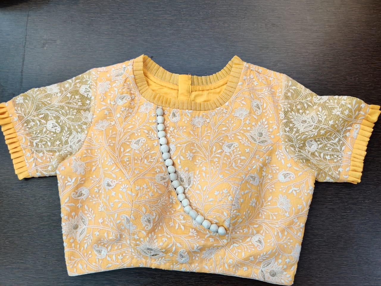 Buy gorgeous yellow embroidered saree blouse online in USA with frill edging. Elevate your Indian saree style with exquisite readymade sari blouses, embroidered saree blouses, Benarasi saree blouse, fancy saree blouse from Pure Elegance Indian clothing store in USA.-front