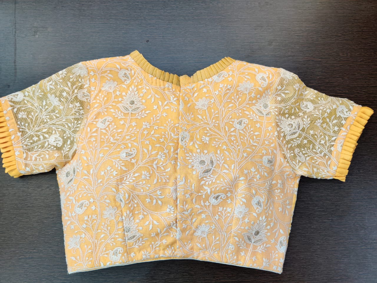 Buy gorgeous yellow embroidered saree blouse online in USA with frill edging. Elevate your Indian saree style with exquisite readymade sari blouses, embroidered saree blouses, Benarasi saree blouse, fancy saree blouse from Pure Elegance Indian clothing store in USA.-back