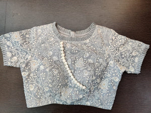 Shop grey embroidered saree blouse online in USA with frill edging. Elevate your Indian saree style with exquisite readymade sari blouses, embroidered saree blouses, Benarasi saree blouse, fancy saree blouse from Pure Elegance Indian clothing store in USA.-front