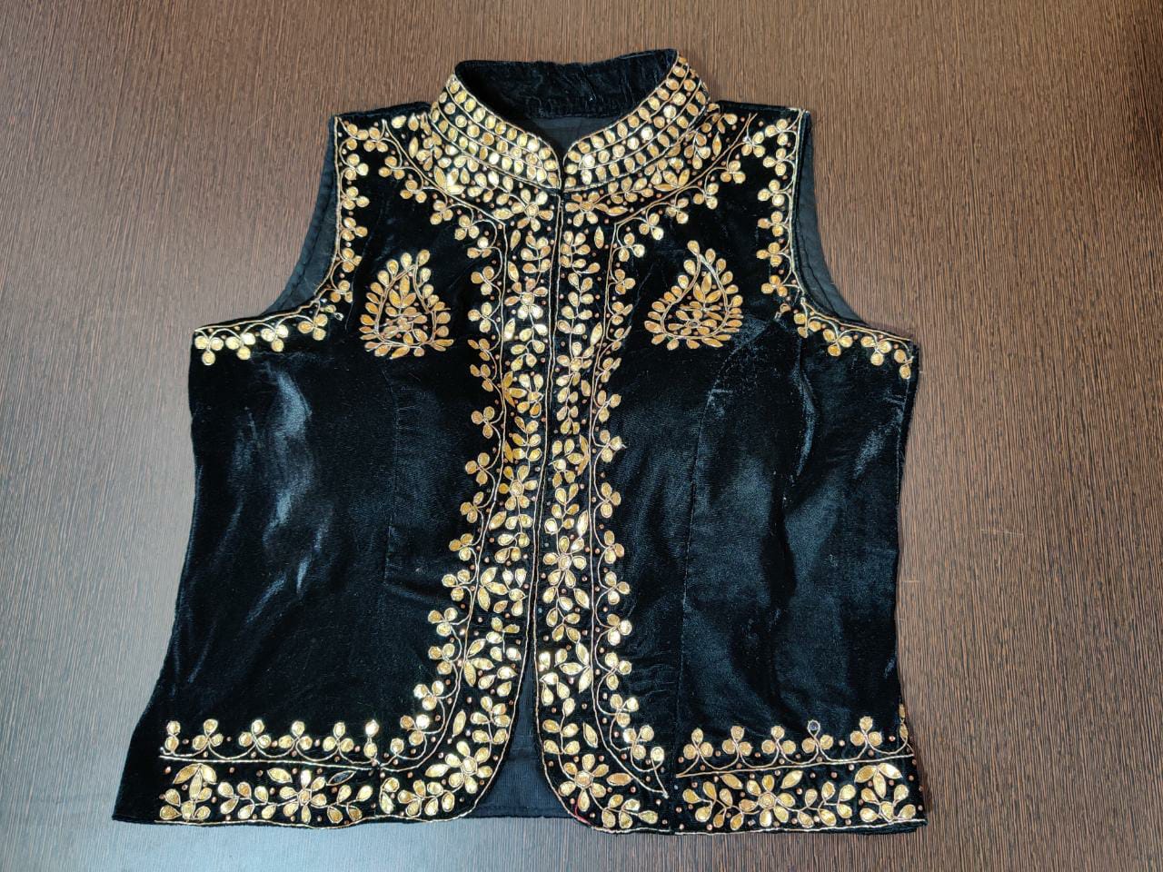 Shop gorgeous black velvet sleeveless saree blouse online in USA with gota patti work. Elevate your Indian saree style with exquisite readymade saree blouses, embroidered saree blouses, Benarasi sari blouse, designer saree blouse from Pure Elegance Indian clothing store in USA.-front