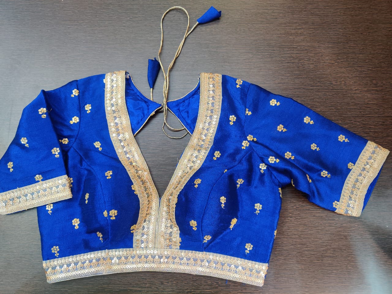 Shop beautiful blue designer sari blouse online in USA with golden embroidery. Elevate your Indian saree style with exquisite readymade sari blouse, embroidered saree blouses, Banarasi sari blouse, designer saree blouse from Pure Elegance Indian clothing store in USA.-front