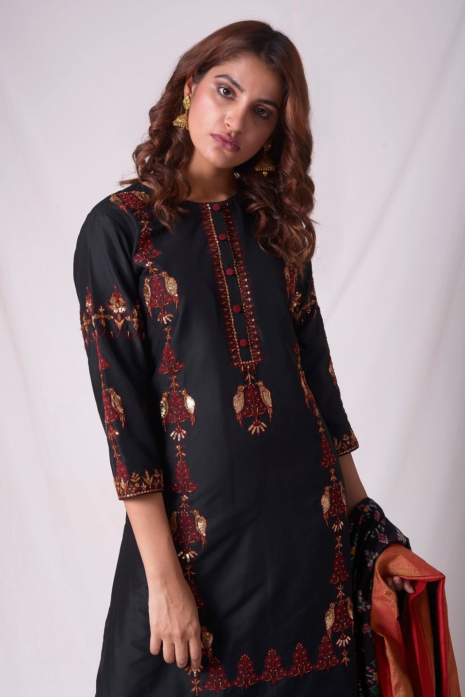 Buy black cotton silk suit online in USA. Suit has simple red  work. Be the talk of parties and weddings with exquisite designer gowns, Indian suits, Anarkali dresses, Indowestern dresses from Pure Elegance Indian clothing store in USA.Shop online now.-close up