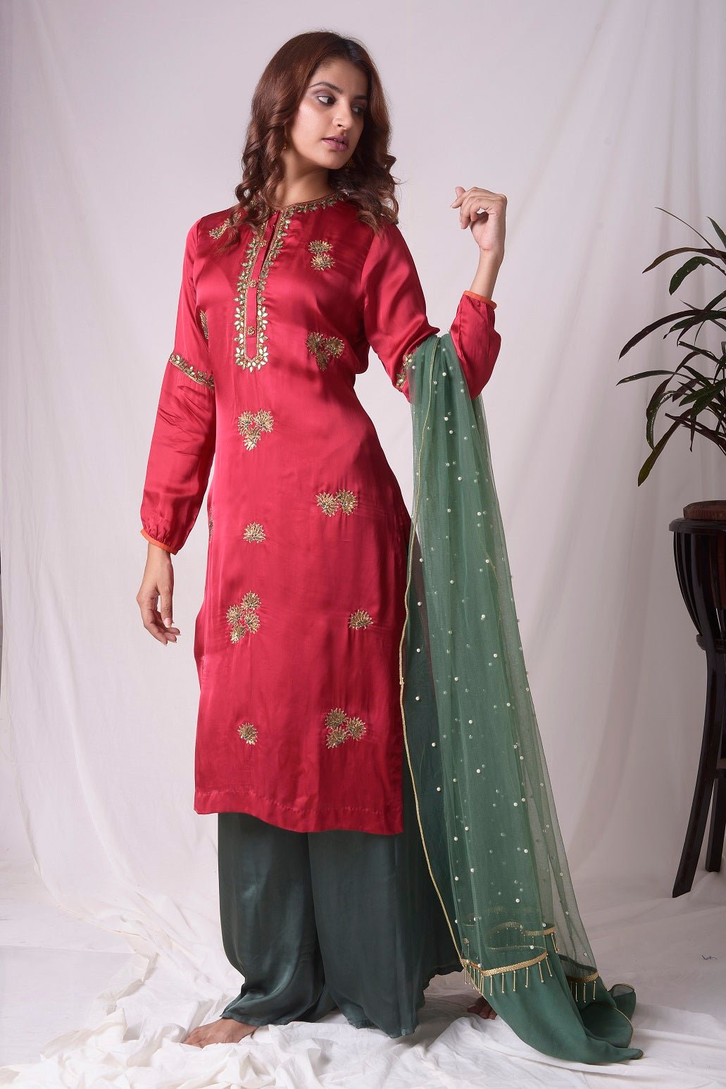 Buy red and green satin suit online in USA with palazzo and dupatta. Be the talk of parties and weddings with exquisite designer gowns, Indian suits, Anarkali dresses, Indowestern dresses from Pure Elegance Indian clothing store in USA.Shop online now.-side view