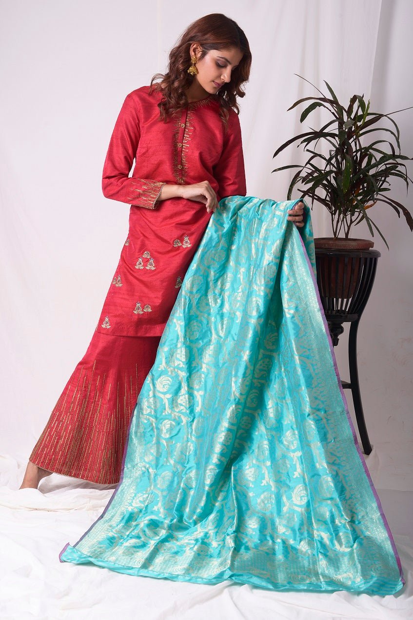 Buy elegant red silk suit online in USA. Suit has gold sequence design work. Kurta has 3/4 length sleeves, high neck, red palazzo and blue dupatta. Simple look makes it elegant.Be the talk of parties and weddings with exquisite designer gowns from Pure Elegance Indian clothing store in USA. Shop online now.-full view-2