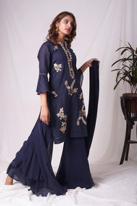 Buy cobalt blue chanderi suit online in USA. Suit has simple gotta patti work,circular flounce sleeves with delicate design,complementing palazzo and duppatta. Simple look makes it elegant.Be the talk of parties and weddings with exquisite designer gowns from Pure Elegance Indian clothing store in USA. Shop online now.-full view 