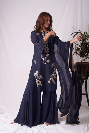 Buy cobalt blue chanderi suit online in USA. Suit has simple gotta patti work,circular flounce sleeves with delicate design,complementing palazzo and duppatta. Simple look makes it elegant.Be the talk of parties and weddings with exquisite designer gowns from Pure Elegance Indian clothing store in USA. Shop online now.-full view- 3