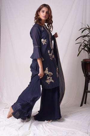 Buy cobalt blue chanderi suit online in USA. Suit has simple gotta patti work,circular flounce sleeves with delicate design,complementing palazzo and duppatta. Simple look makes it elegant.Be the talk of parties and weddings with exquisite designer gowns from Pure Elegance Indian clothing store in USA. Shop online now.-full view-4