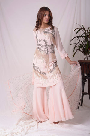 Buy pink georgette suit online in USA. Suit has gold and grey design work. Kurta has long sleeves. Suit had baby pink palazzo and pink net duppatta. Simple look makes it elegant. Be the talk of parties and weddings with exquisite designer gowns from Pure Elegance Indian clothing store in USA. Shop online now.-full view-1