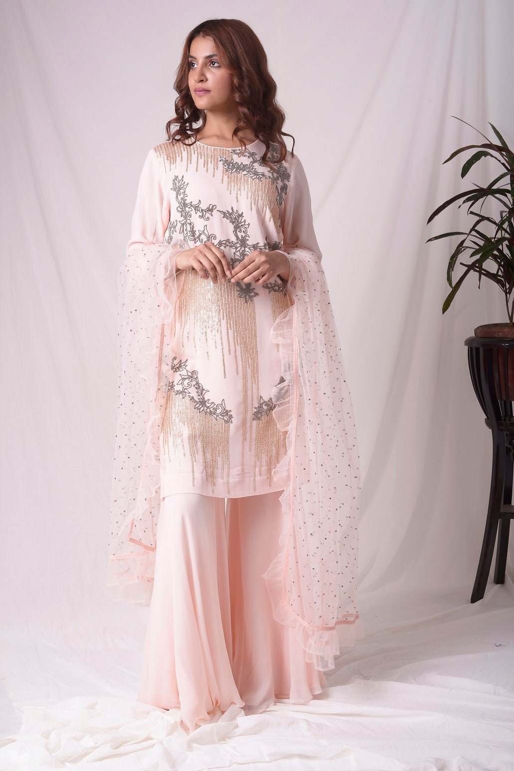 Buy pink georgette suit online in USA. Suit has gold and grey design work. Kurta has long sleeves. Suit had baby pink palazzo and pink net duppatta. Simple look makes it elegant. Be the talk of parties and weddings with exquisite designer gowns from Pure Elegance Indian clothing store in USA. Shop online now.-full view-2