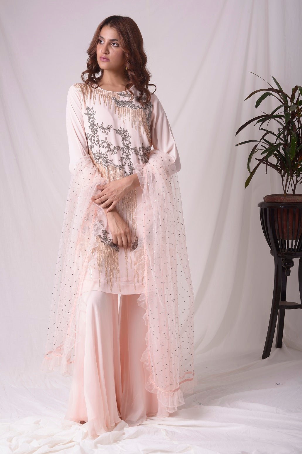 Buy pink georgette suit online in USA. Suit has gold and grey design work. Kurta has long sleeves. Suit had baby pink palazzo and pink net duppatta. Simple look makes it elegant. Be the talk of parties and weddings with exquisite designer gowns from Pure Elegance Indian clothing store in USA. Shop online now.-full view-3