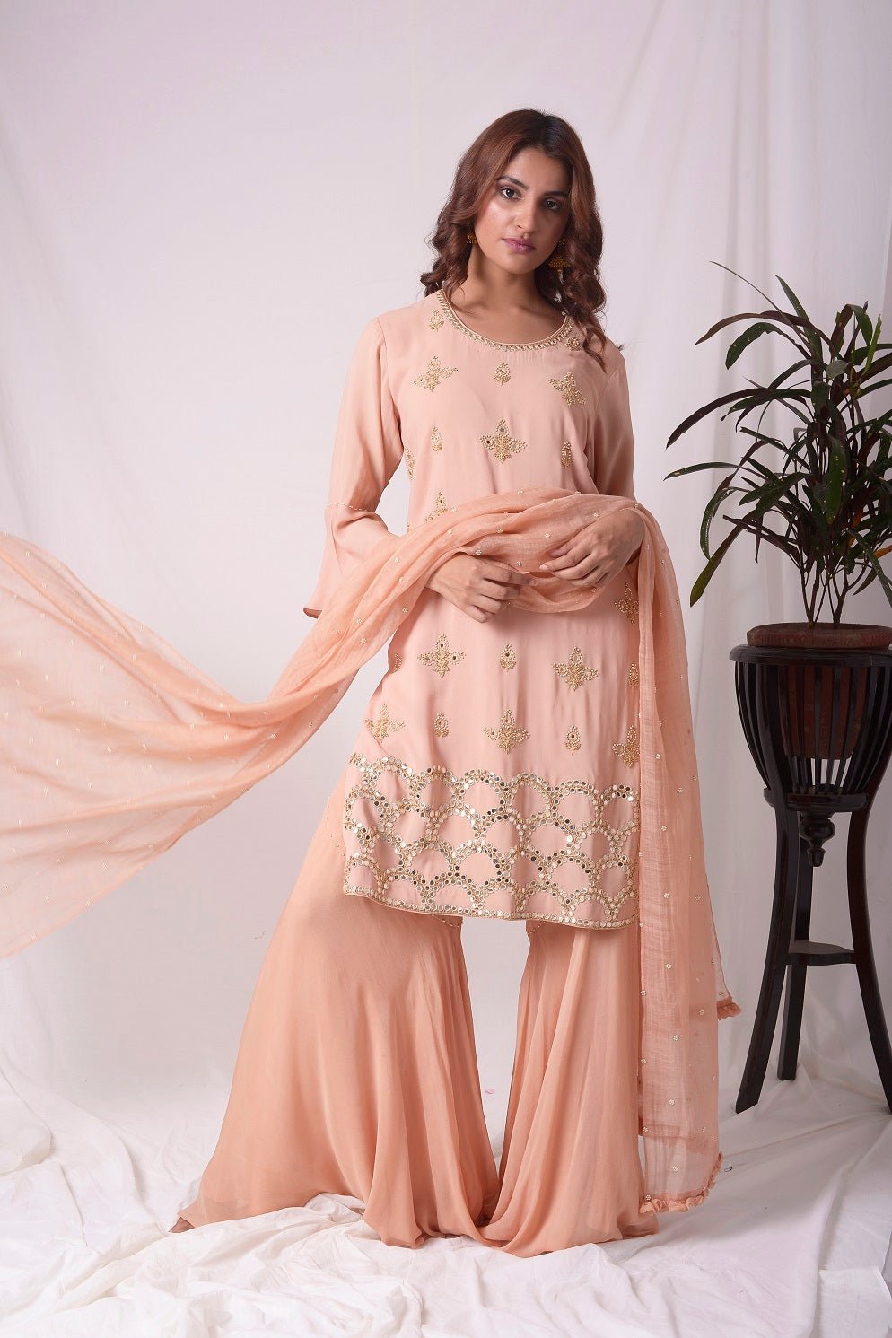 Buy peach orange georgette suit online in USA. Suit has fine gold design work. Kurta has 3/4 length sleeves, orange palazzo, duppatta with gold design. Simple look makes it elegant. Be the talk of parties and weddings with exquisite designer gowns from Pure Elegance Indian clothing store in USA. Shop online now.-full view-3