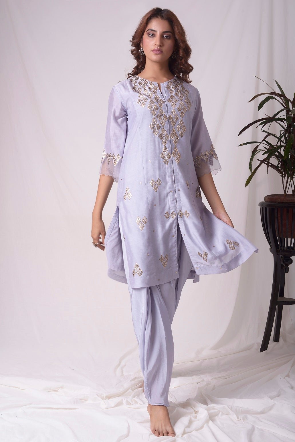 Buy lavender embroidered chanderi suit online in USA. Suit has simple golden work. Kurta has 3/4 length sleeves with net like at border, dhoti and rhombus neckline. Simple look makes it elegant. Be the talk of parties and weddings with exquisite designer gowns from Pure Elegance Indian clothing store in USA. Shop online now.-full view-2