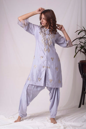 Buy lavender embroidered chanderi suit online in USA. Suit has simple golden work. Kurta has 3/4 length sleeves with net like at border, dhoti and rhombus neckline. Simple look makes it elegant. Be the talk of parties and weddings with exquisite designer gowns from Pure Elegance Indian clothing store in USA. Shop online now.-full view-4