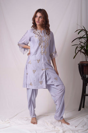 Buy lavender embroidered chanderi suit online in USA. Suit has simple golden work. Kurta has 3/4 length sleeves with net like at border, dhoti and rhombus neckline. Simple look makes it elegant. Be the talk of parties and weddings with exquisite designer gowns from Pure Elegance Indian clothing store in USA. Shop online now.-full view-5